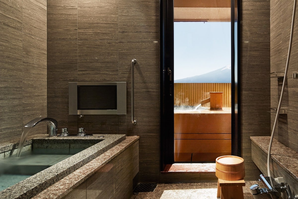 japanese western style deluxe room with open air bath, mountain view | bathroom | separate bathtub and shower, free toiletries, hair dryer, slippers