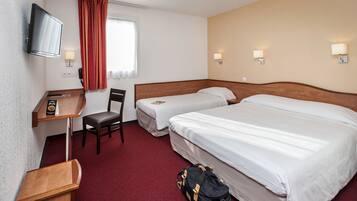 A hotel room with two beds, a desk with a chair, a TV, and a window with curtains.