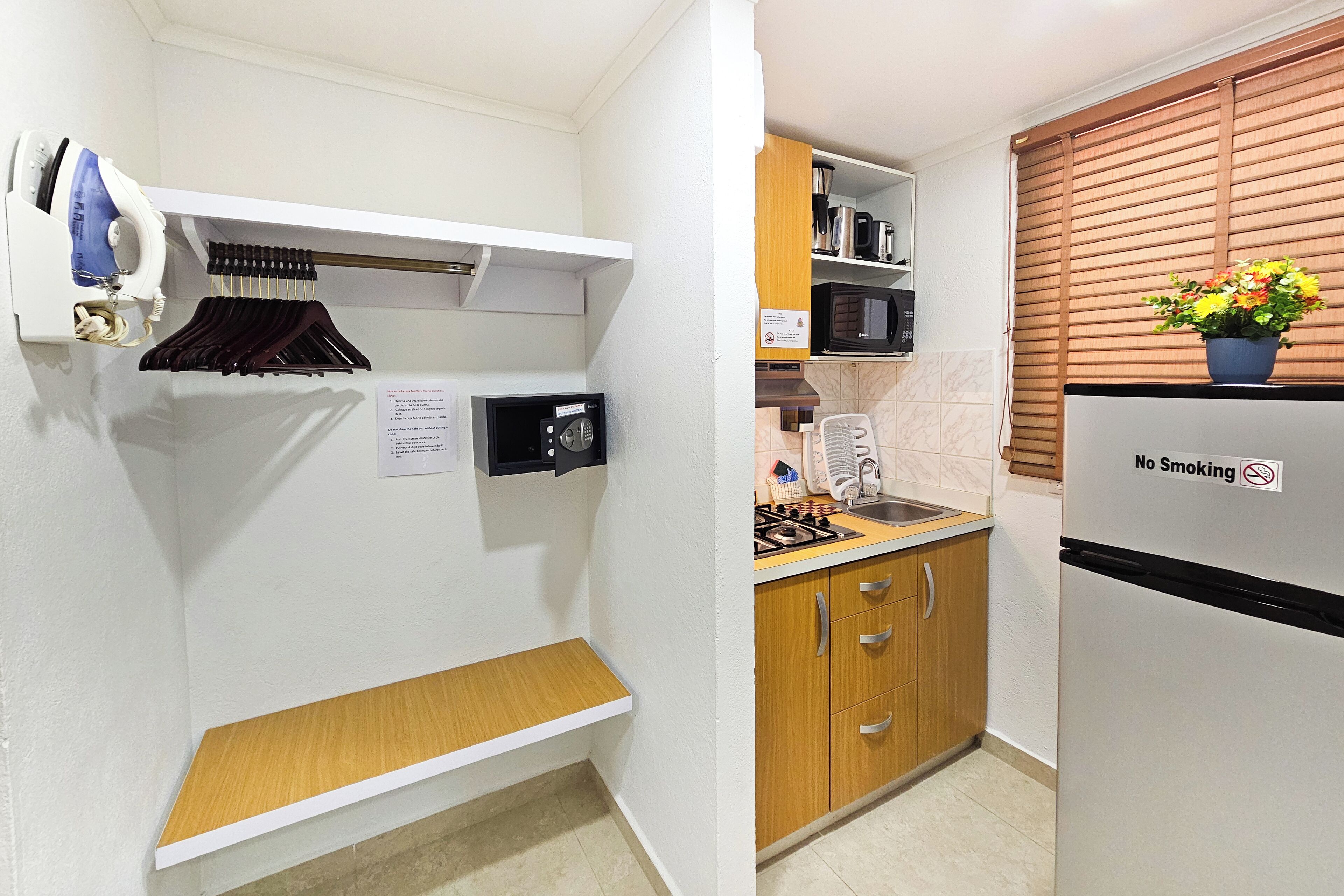 Una cocina compacta con microondas integrado, estufa y refrigerador.