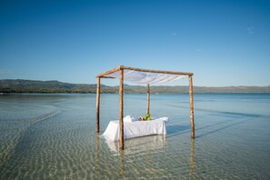 On the beach, white sand, beach umbrellas, beach towels