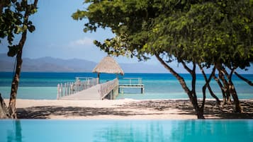 On the beach, white sand, beach umbrellas, beach towels