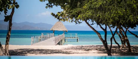 On the beach, white sand, beach umbrellas, beach towels