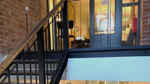 A multi-level interior with a staircase, a kitchen area, and a dining space. - Hostel Suomenlinna (Helsinki)