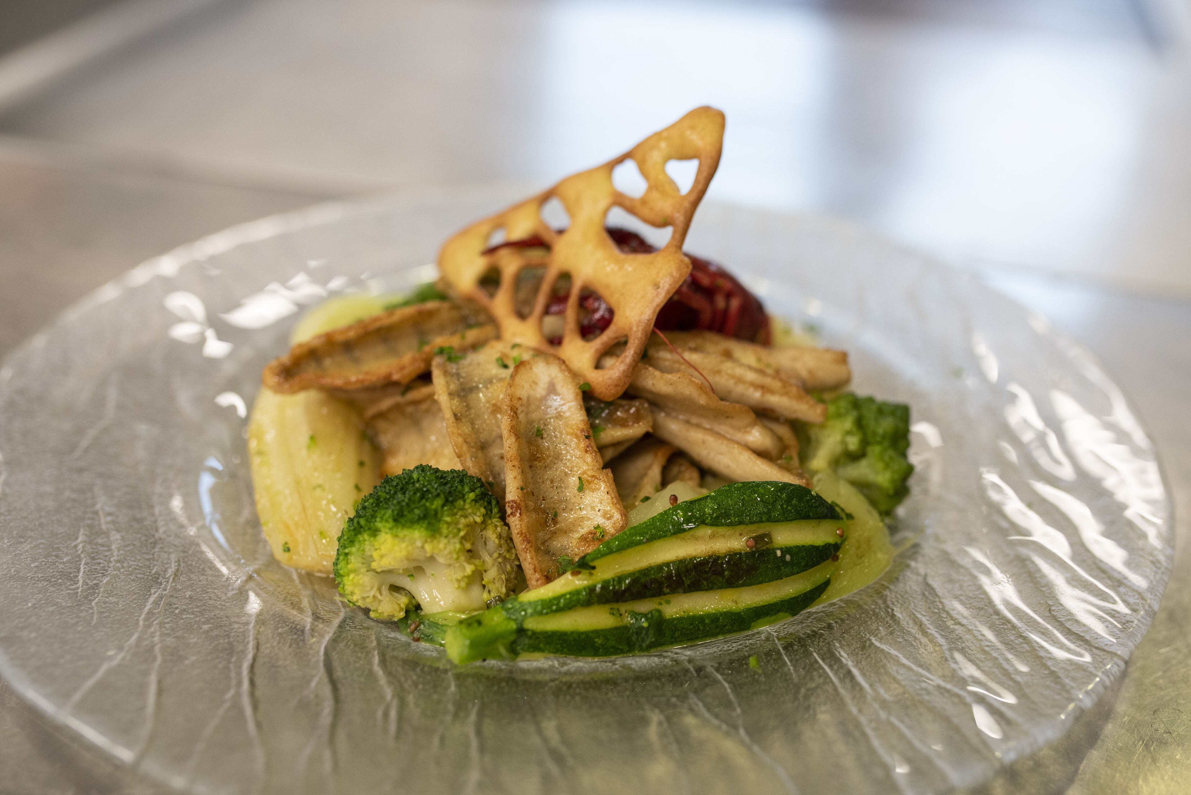 A plate of food with vegetables and a decorative item.