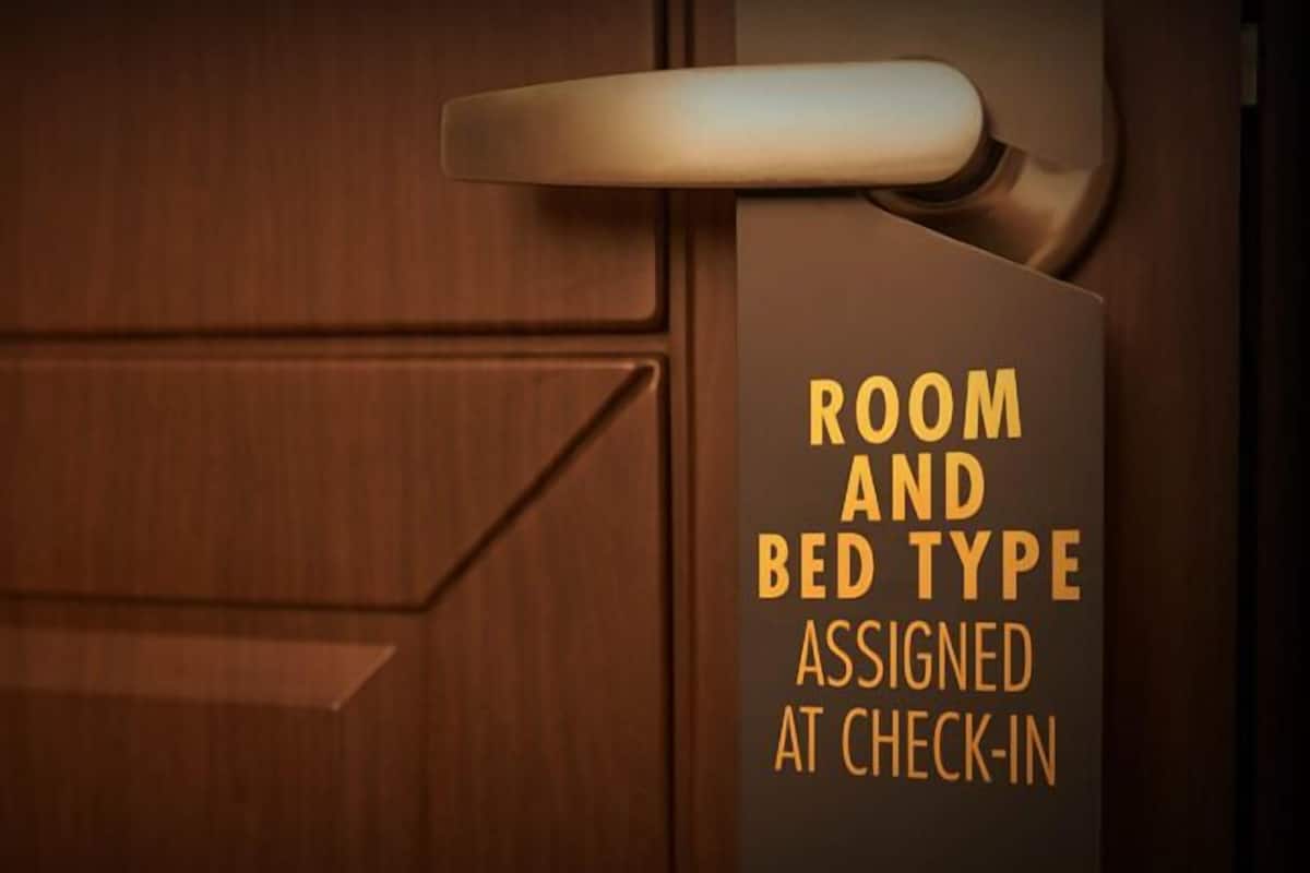 A wooden door with a sign indicating room and bed type assigned at check-in.