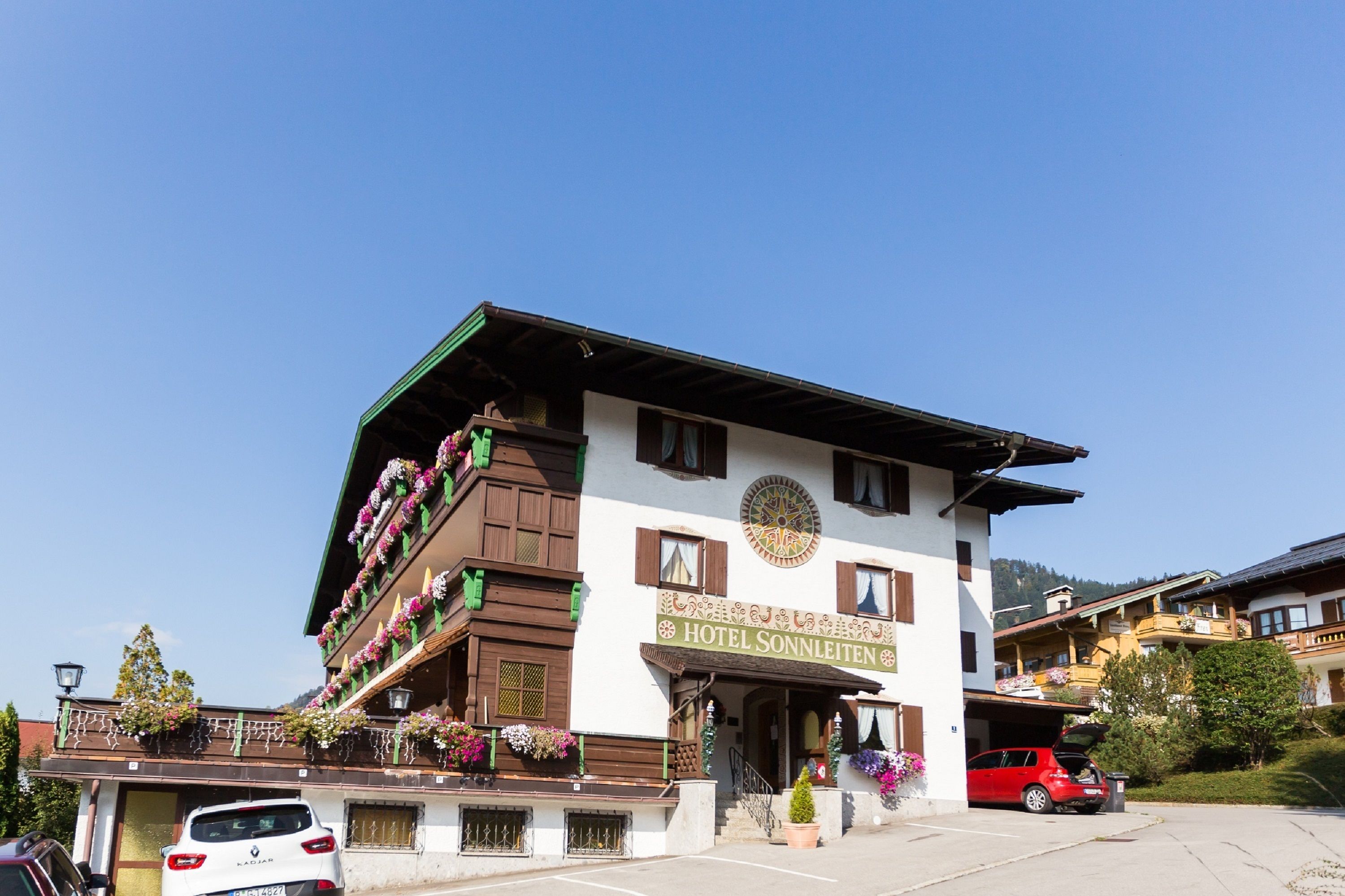 A traditional hotel with a sign reading "HOTEL SONNLEITEN".