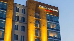 A multi-story building with a prominent sign for "Residence Inn Marriott".