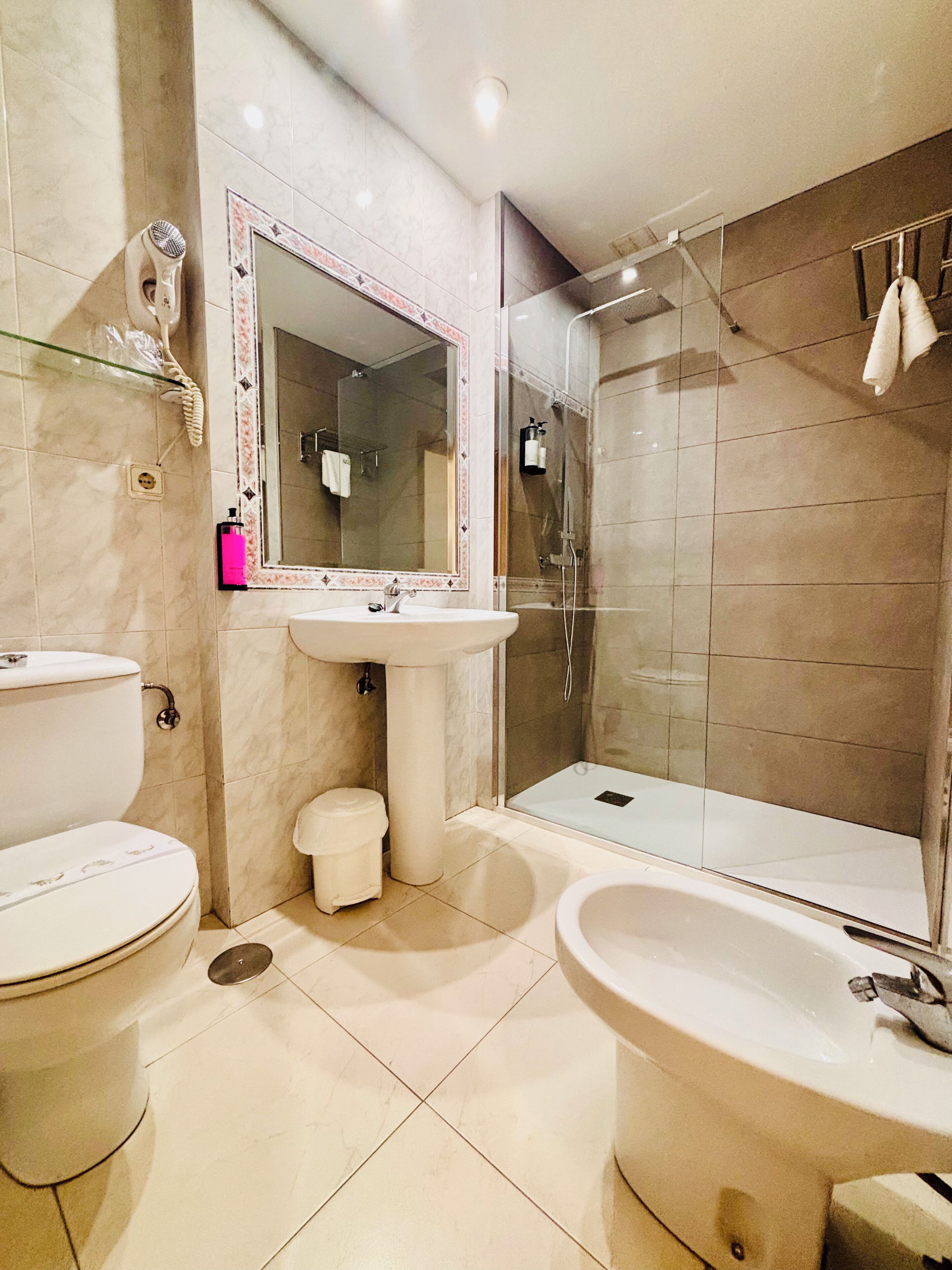 A bathroom with a toilet, sink, and bathtub.