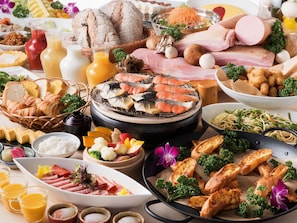 A variety of food items including grilled fish, bread, and vegetables.