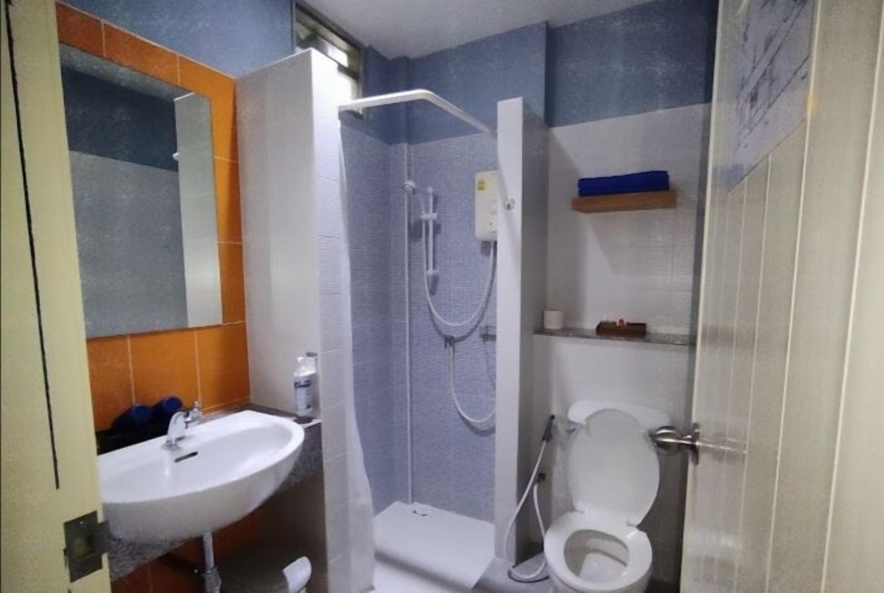 A bathroom with a sink, toilet, and shower.