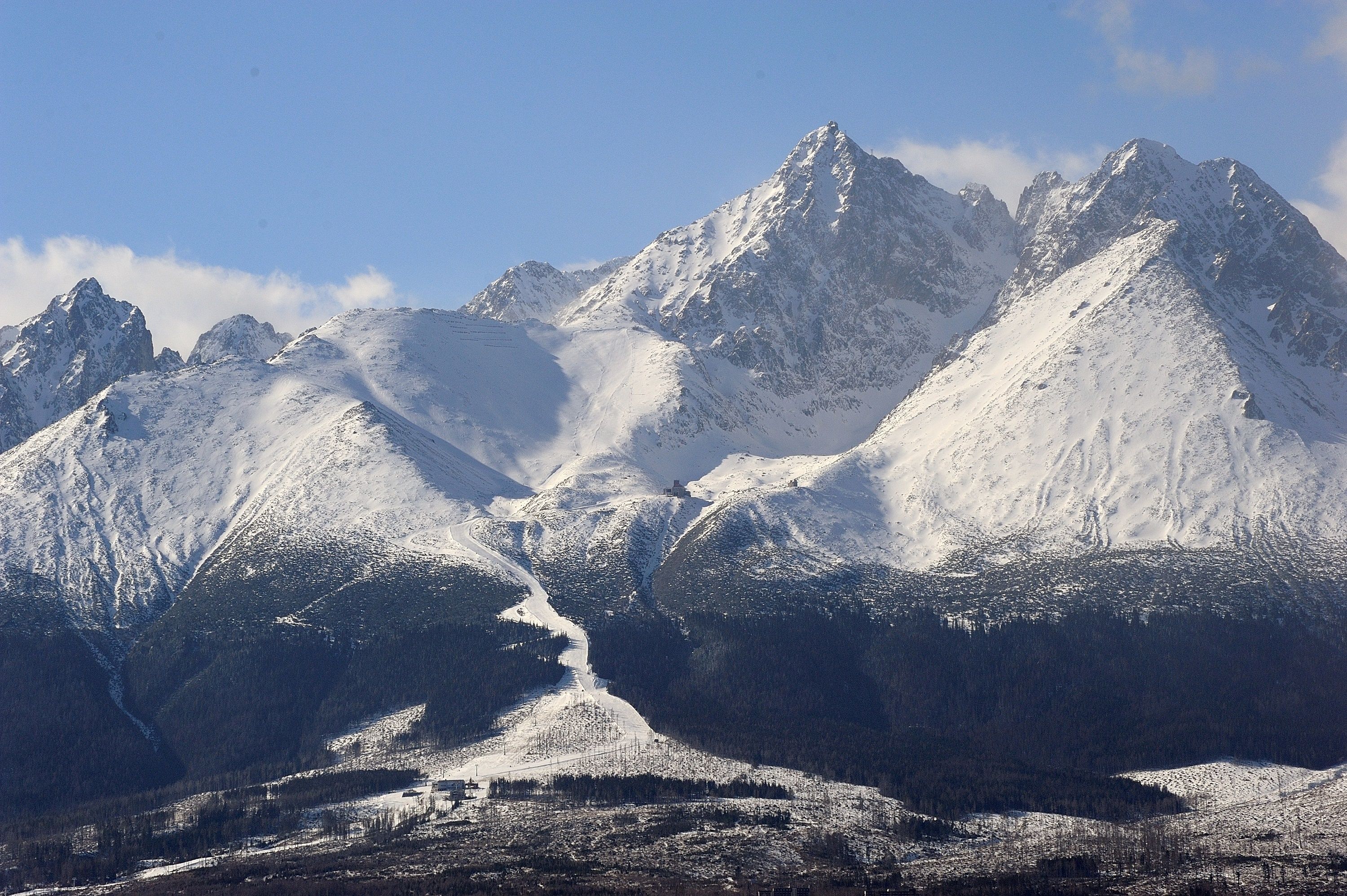 A snow-covered mountain range with a clear sky.