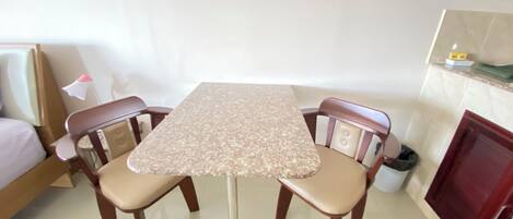 A small dining area with a table and four chairs.