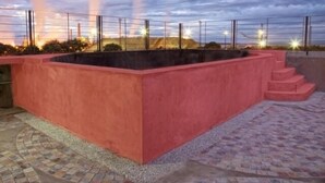 A rooftop pool area with a red border and steps leading down to the pool. - Munay Ledesma (Libertador General San Martin)