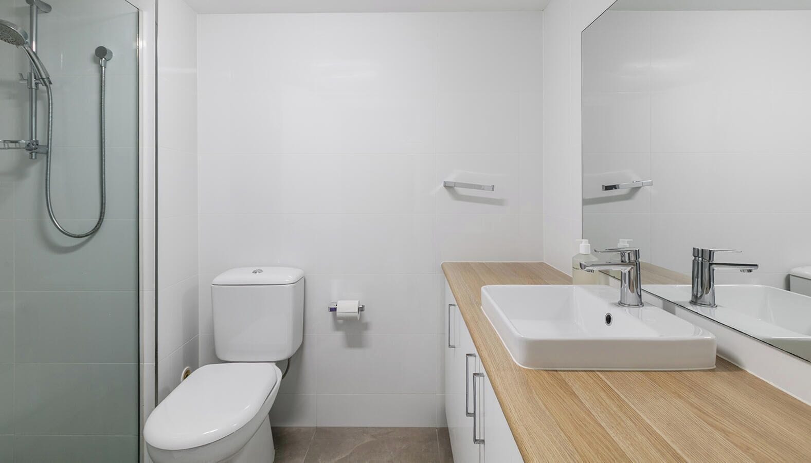 A modern bathroom with a toilet, bidet, and shower.
