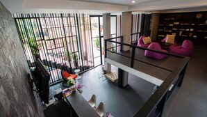 A modern interior with a dining area, seating, and a staircase. - Siwa House (Pattaya)