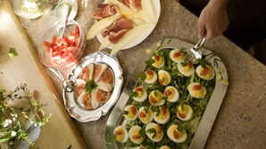A buffet table with various dishes, including salads, meats, and a tray of deviled eggs. - Hotel Sonne (Tux)