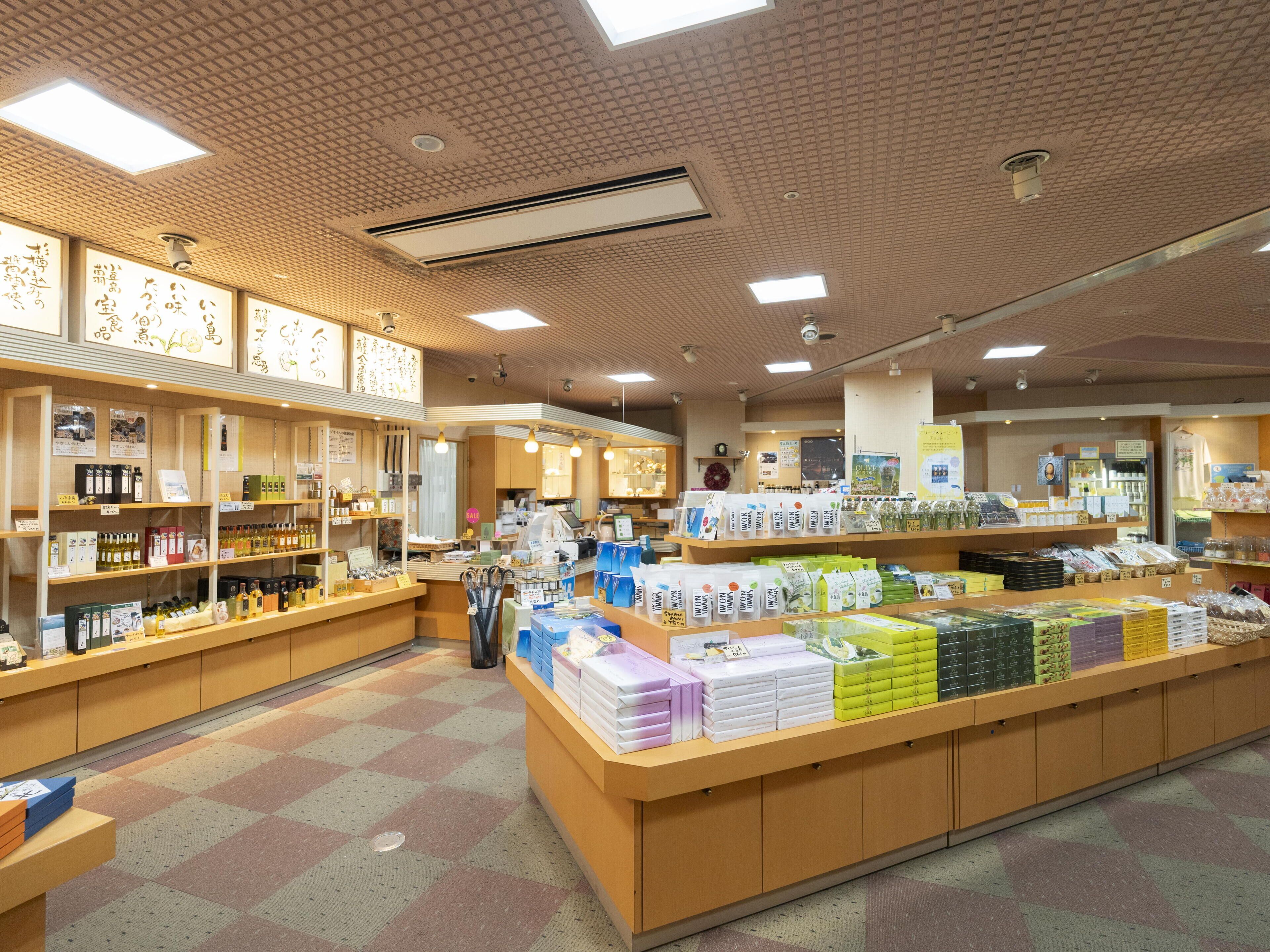 A well-lit store with wooden shelves stocked with various products.
