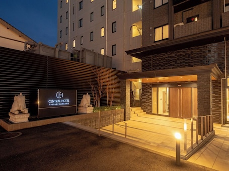 The exterior of the Central Hotel with a modern design, featuring a large signboard, a stone elephant sculpture, and a well-lit entrance.