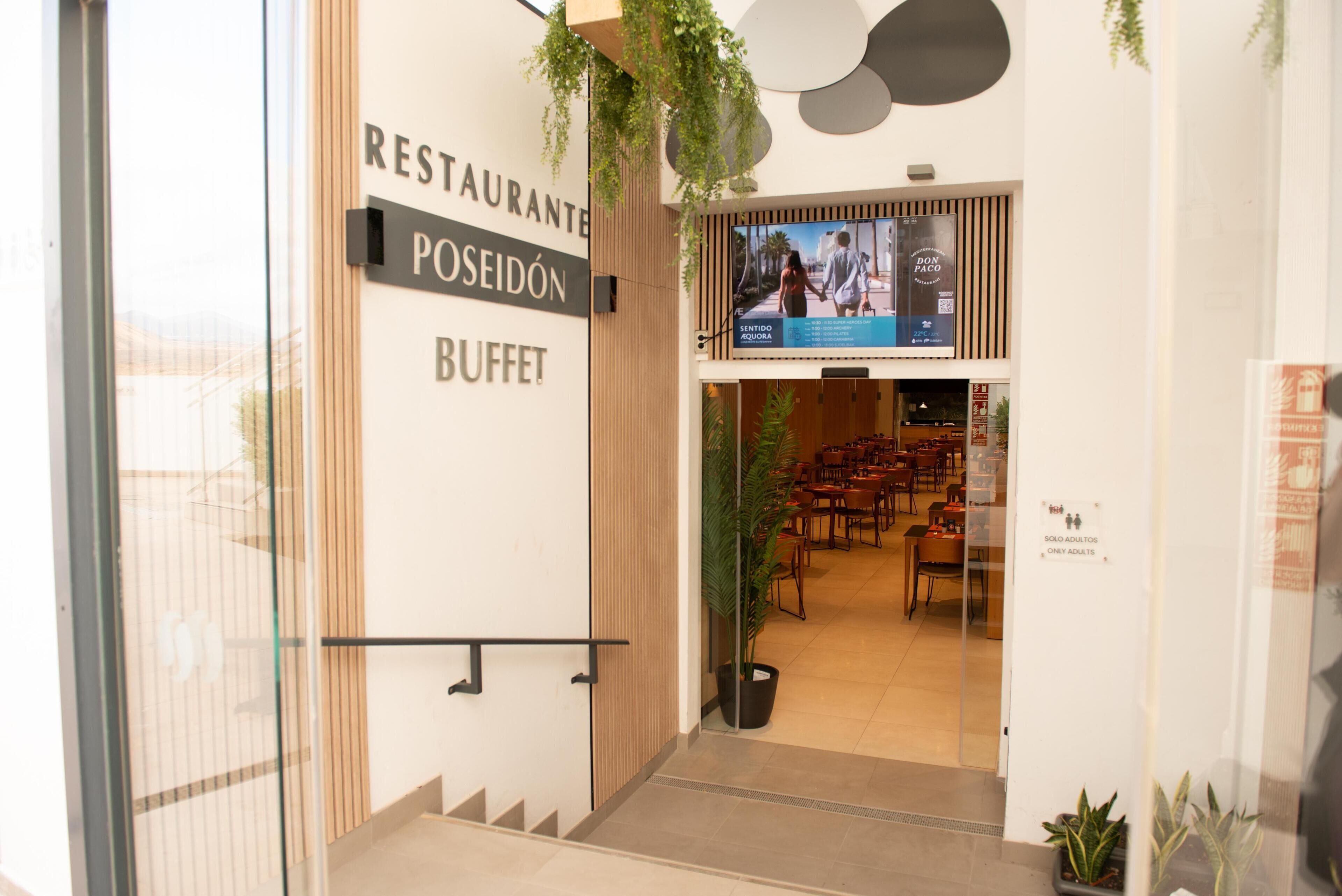 A restaurant entrance with a sign reading "RESTAURANTE POSEIDÓN BUFFET".