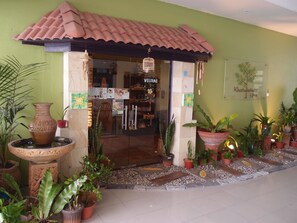 A spa entrance with a tiled roof, a welcome sign, and various potted plants. - Tanjong Puteri Golf Resort - Malaysia (Pasir Gudang)