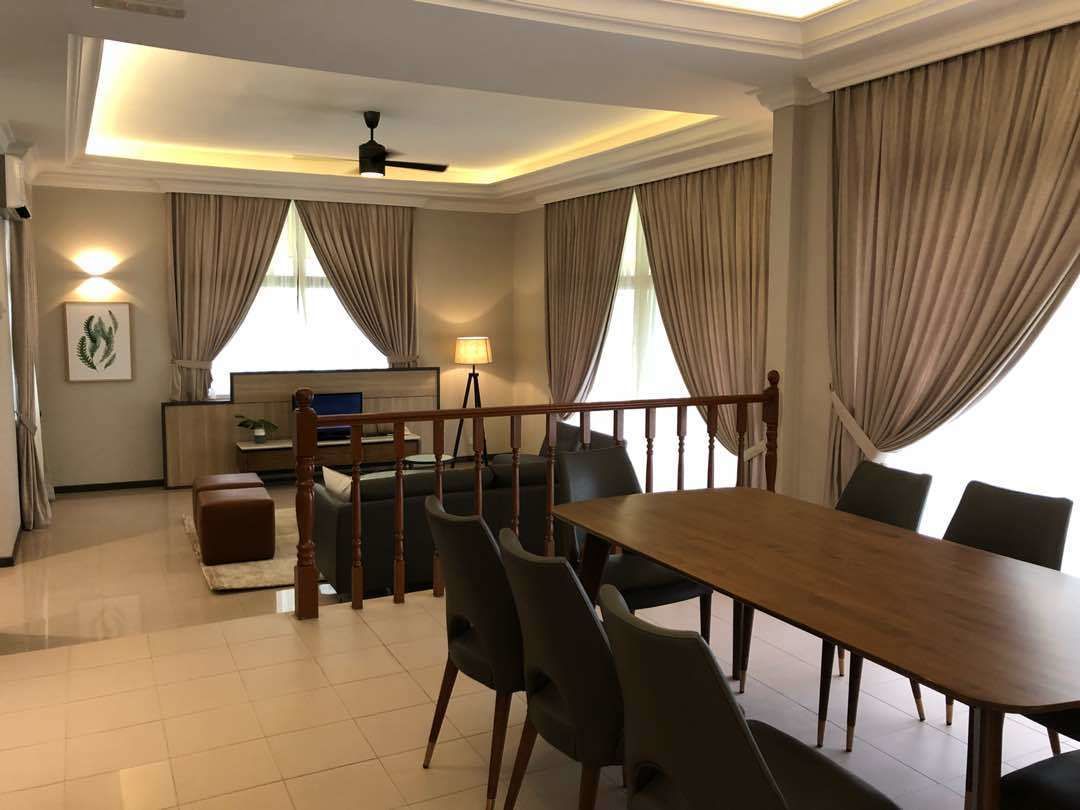 A hotel room with a dining area, a sofa, a lamp, and a ceiling fan.