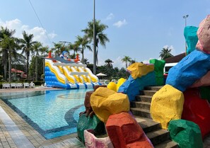 A swimming pool with colorful rock structures and a water slide. - Tanjong Puteri Golf Resort - Malaysia (Pasir Gudang)