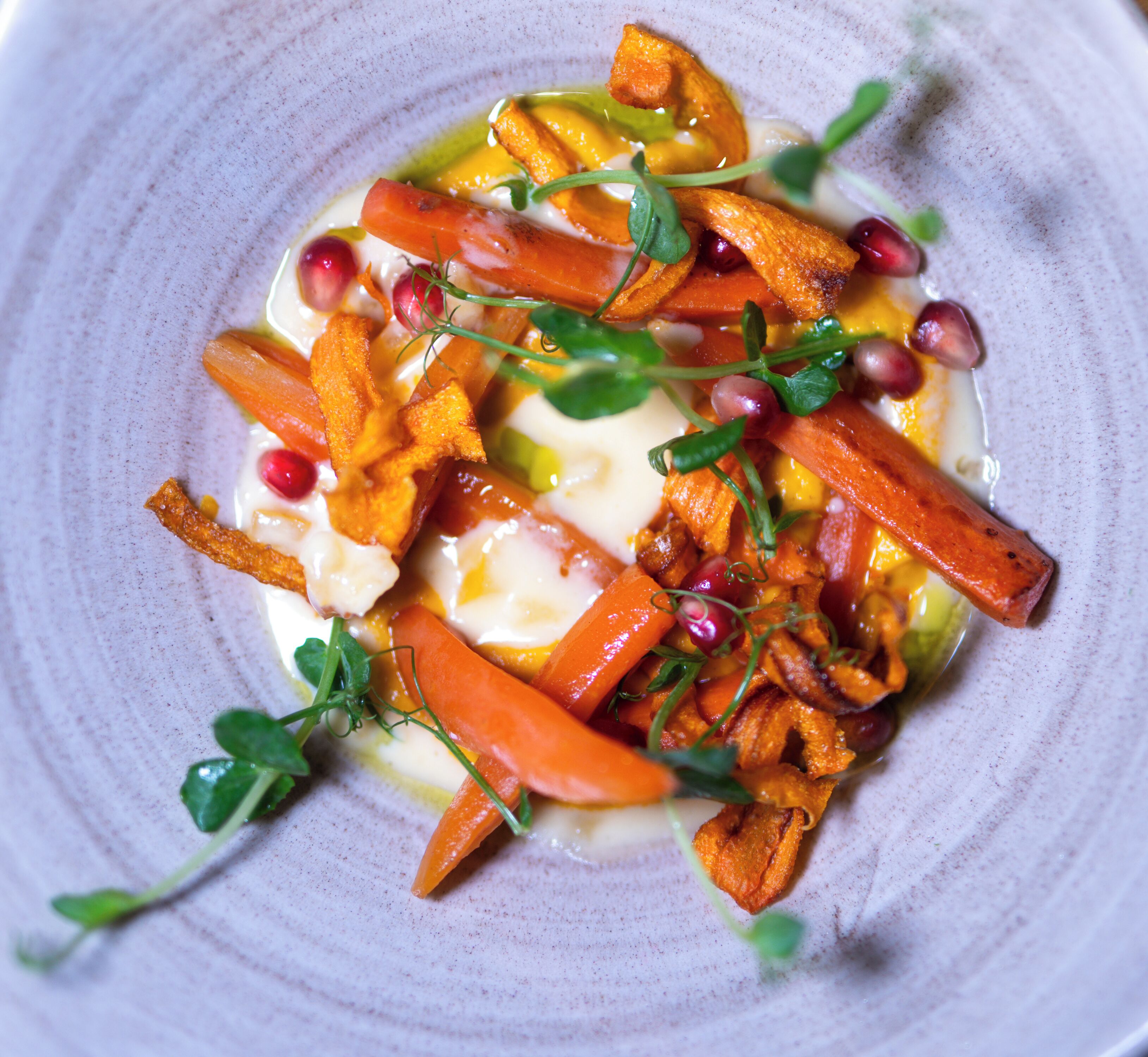 A plate of food with various vegetables and garnishes.