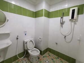 A bathroom with a toilet, sink, and shower.