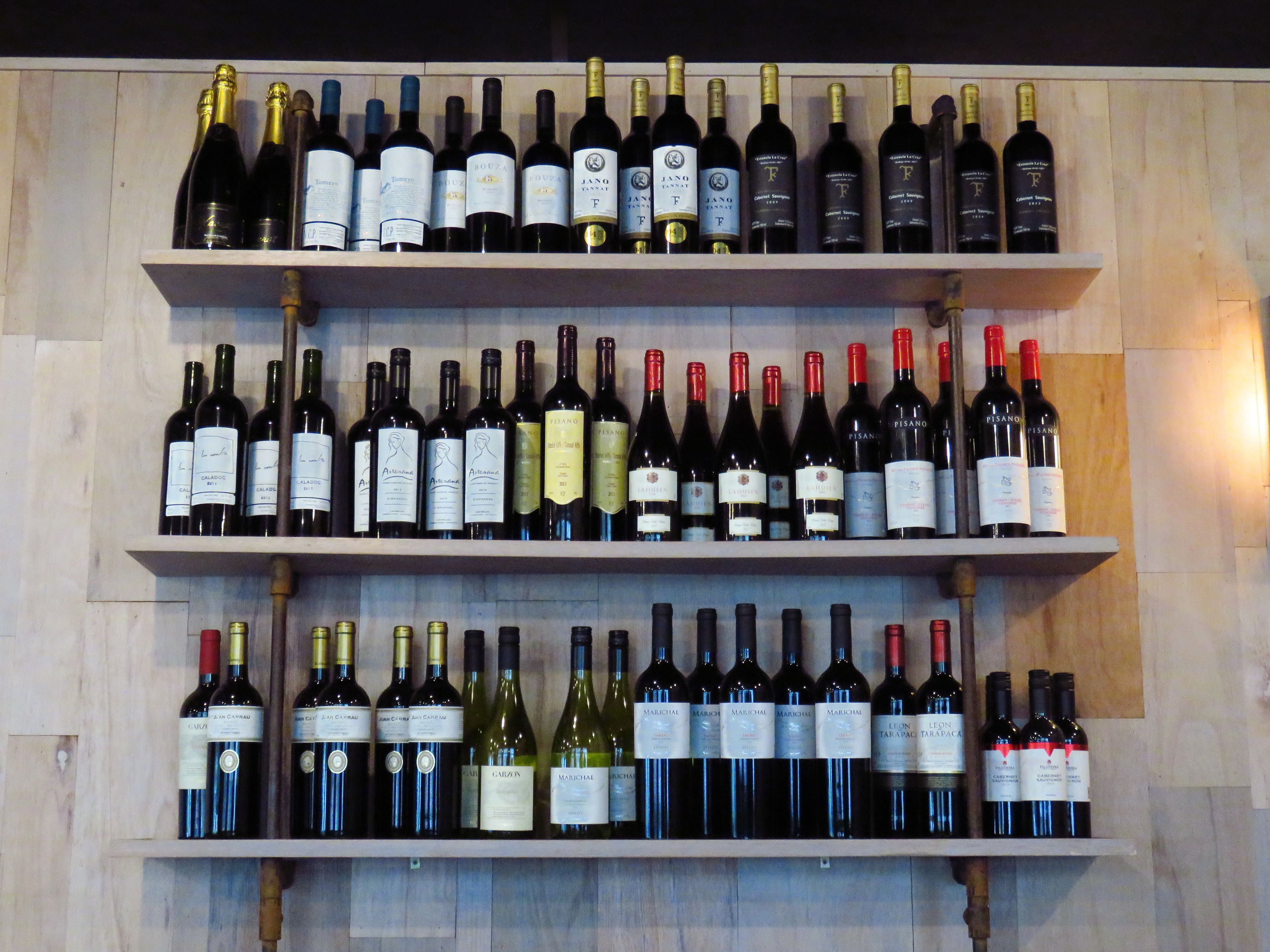 A wine rack with multiple bottles of wine.