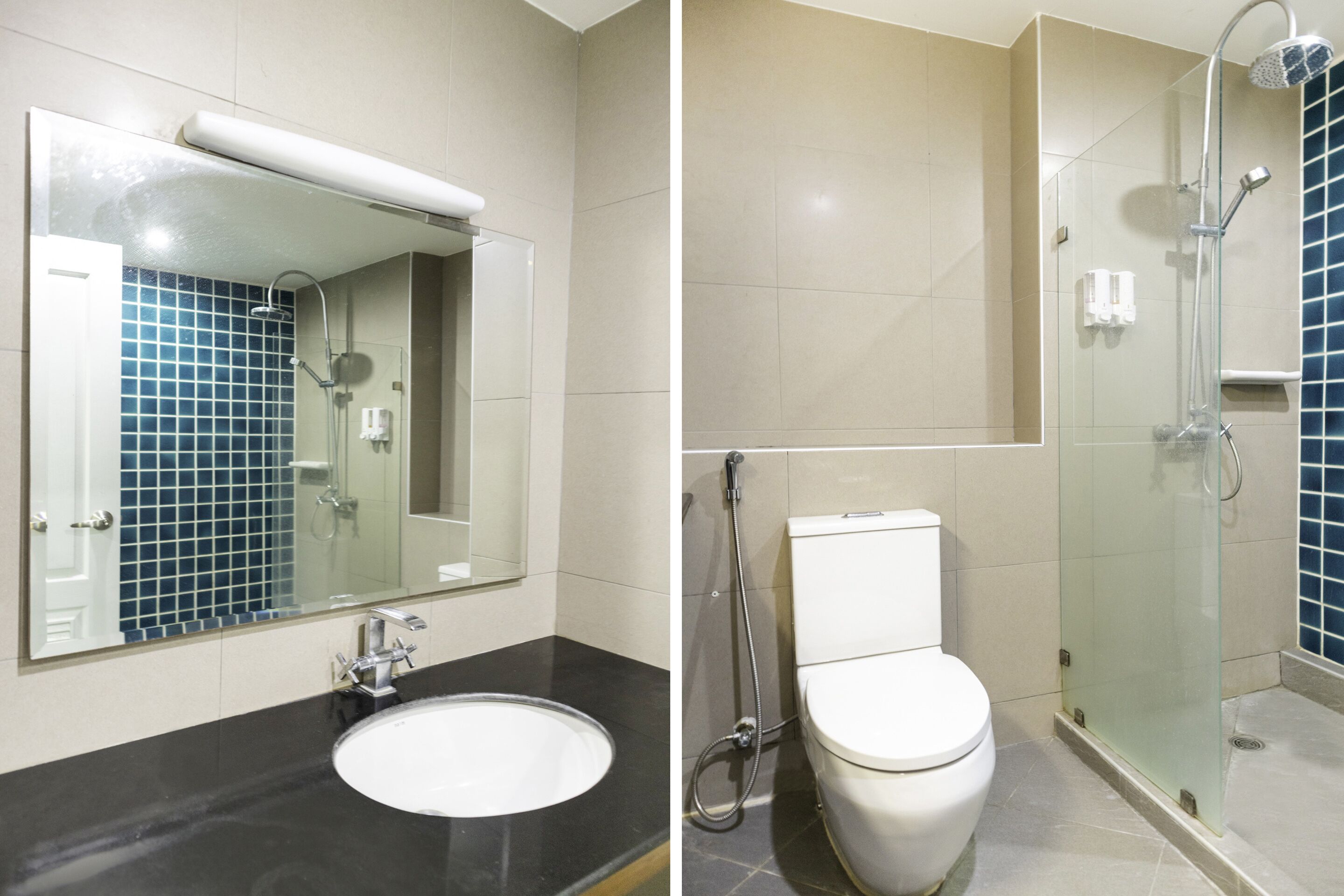 A bathroom with a sink, toilet, and glass-enclosed shower.
