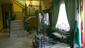 A room with a bunk bed, a staircase, and a glass display cabinet. - Hotel Mitra (Cabra)