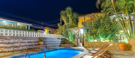 Outdoor pool, open 10 AM to 9 PM, pool umbrellas, pool loungers