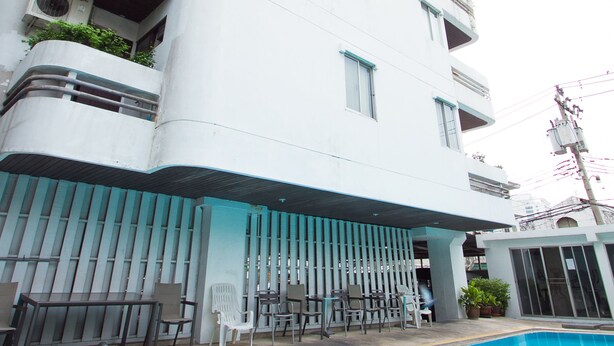A modern building with a swimming pool, outdoor seating, and balconies with plants. - The XP Bangkok (Bangkok)