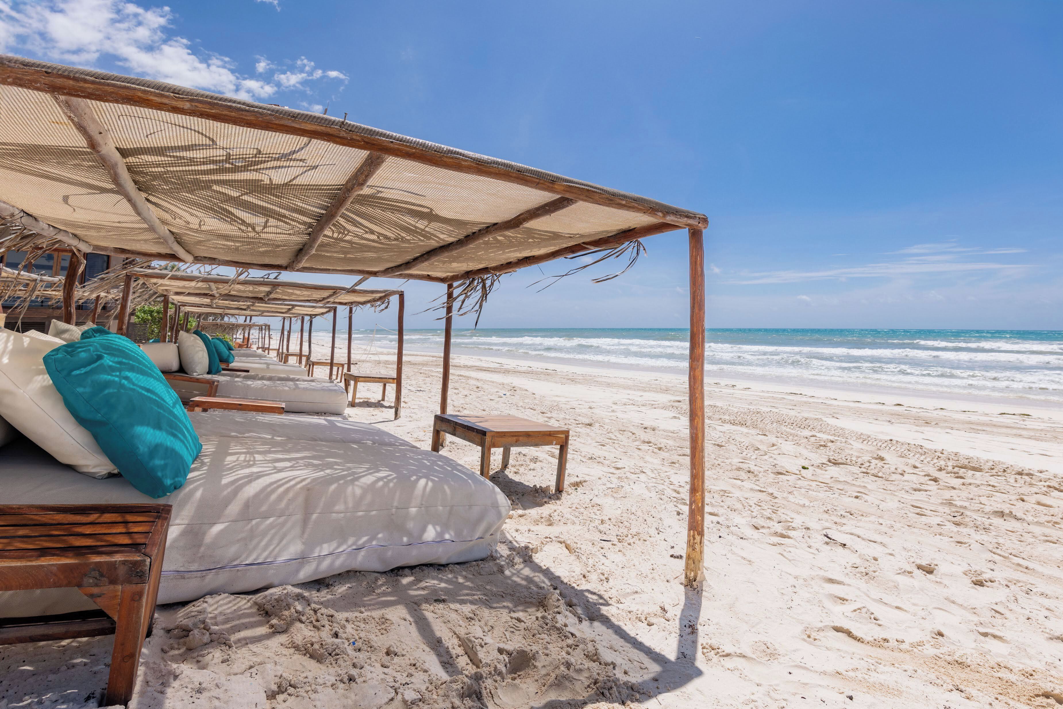 On the beach, white sand, sun loungers, beach umbrellas