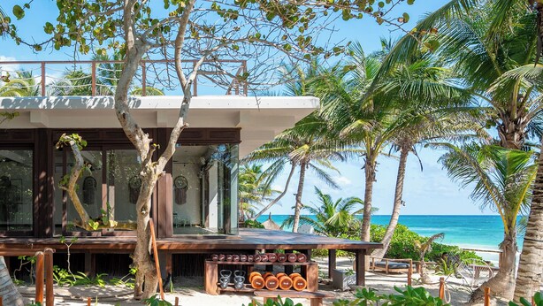 A beachside resort with a wooden deck, outdoor seating, and a view of the ocean. - La Zebra Tulum - a Small Luxury Hotel (Tulum)