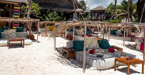 On the beach, white sand, sun-loungers, beach umbrellas