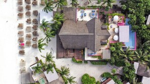 An aerial view of a resort with multiple buildings, a pool area, and numerous palm trees. - La Zebra Tulum - a Small Luxury Hotel (Tulum)