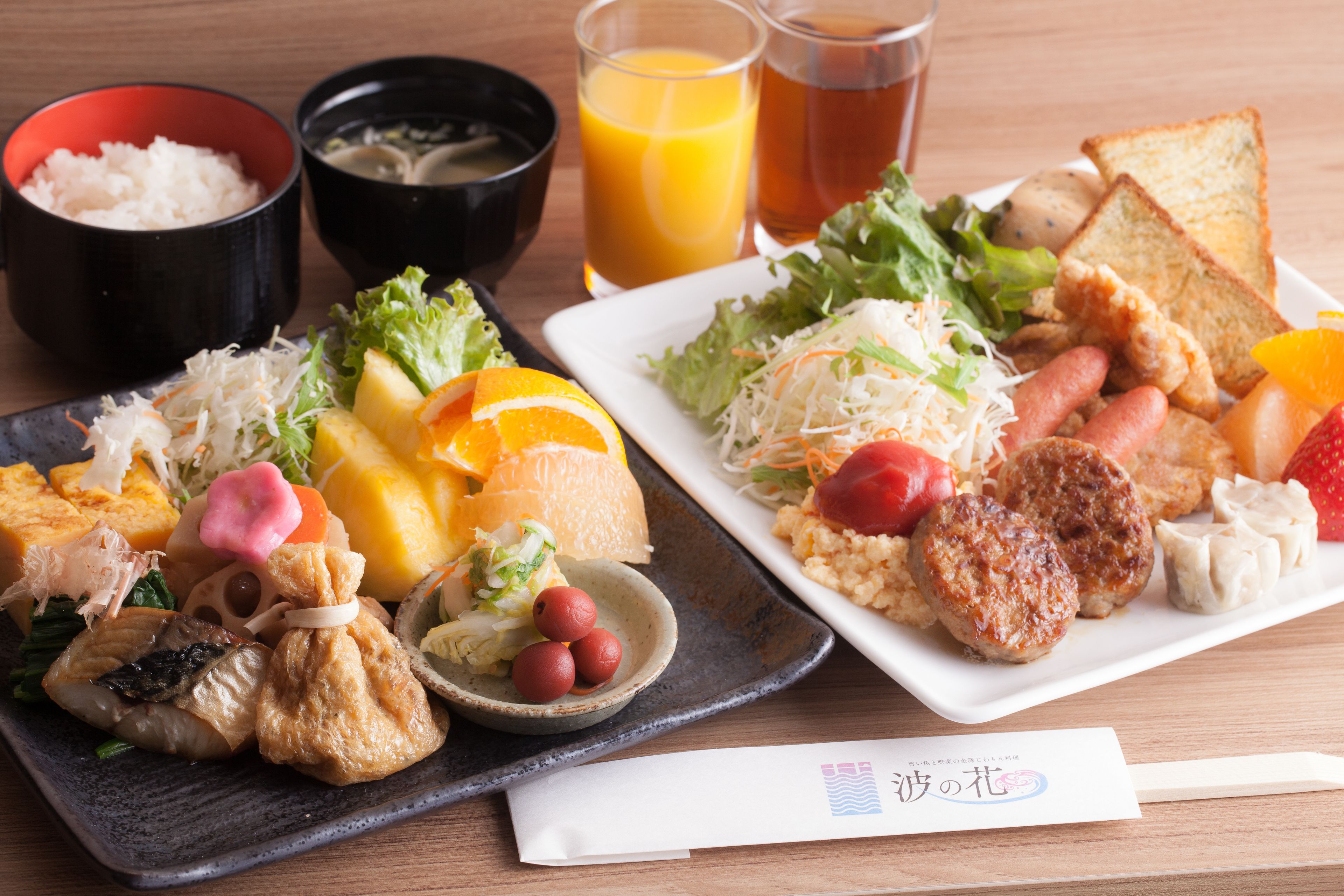 A meal with various dishes including rice, soup, and a salad on a wooden table.