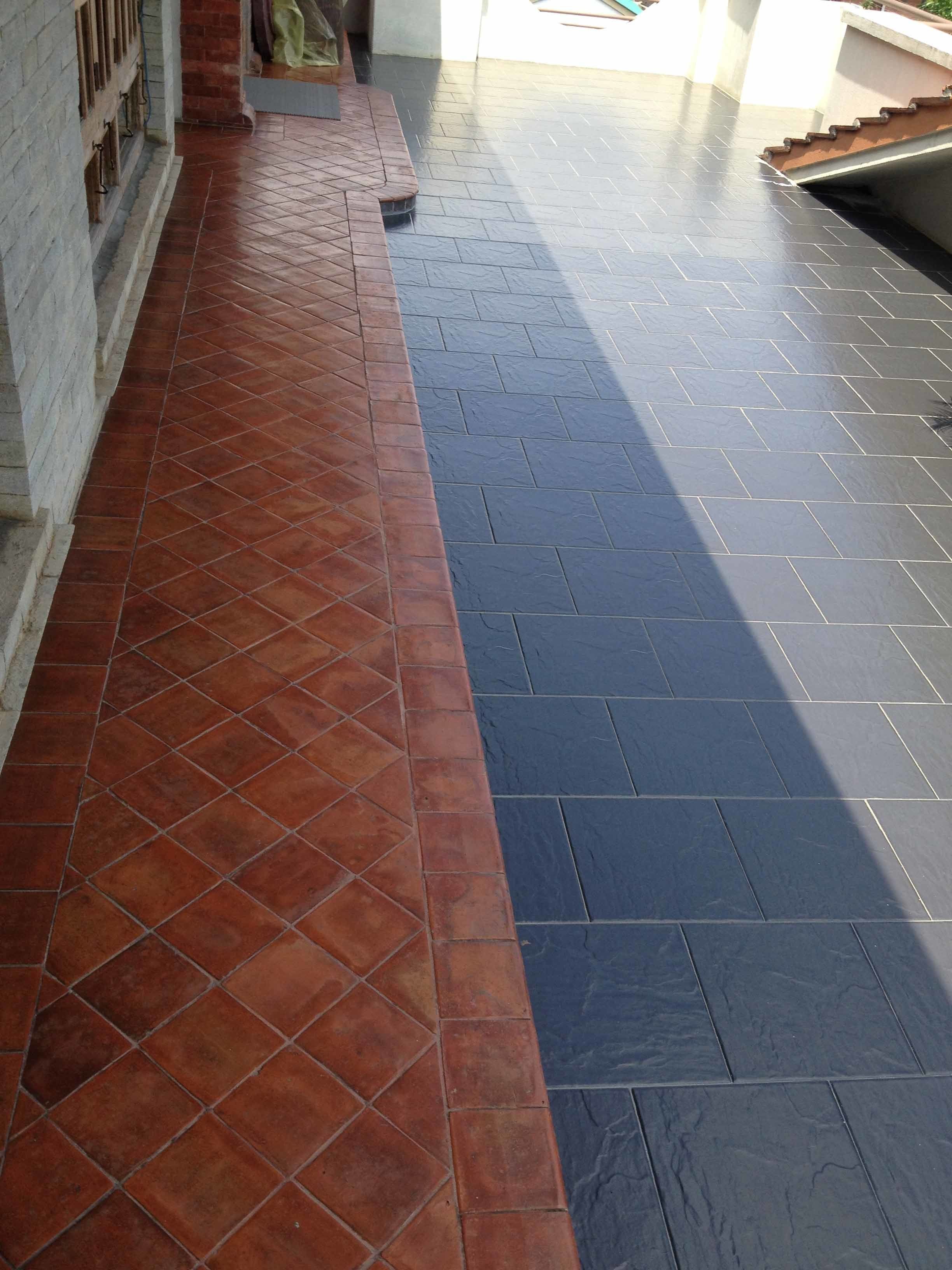 A tiled patio with a red and black pattern.