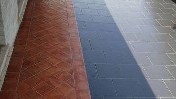 A tiled patio with a red and black pattern.