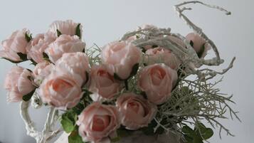 A bouquet of pink roses in a rustic vase.