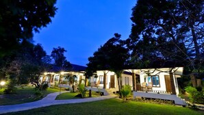 A modern hotel with multiple rooms, a well-maintained garden, and a clear view of the night sky. - Thalane Resort (Krabi)