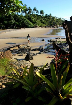 On the beach, white sand, sun-loungers, beach towels