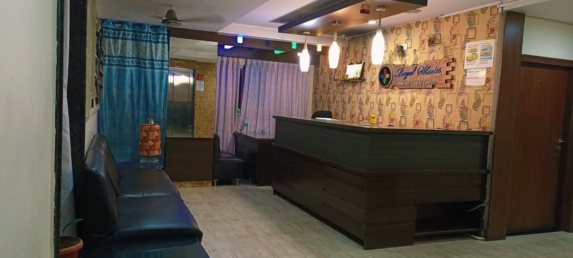 A reception area with a reception desk, a sofa, and a curtain.
