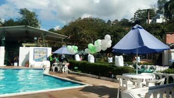 Outdoor pool, a waterfall pool, pool loungers