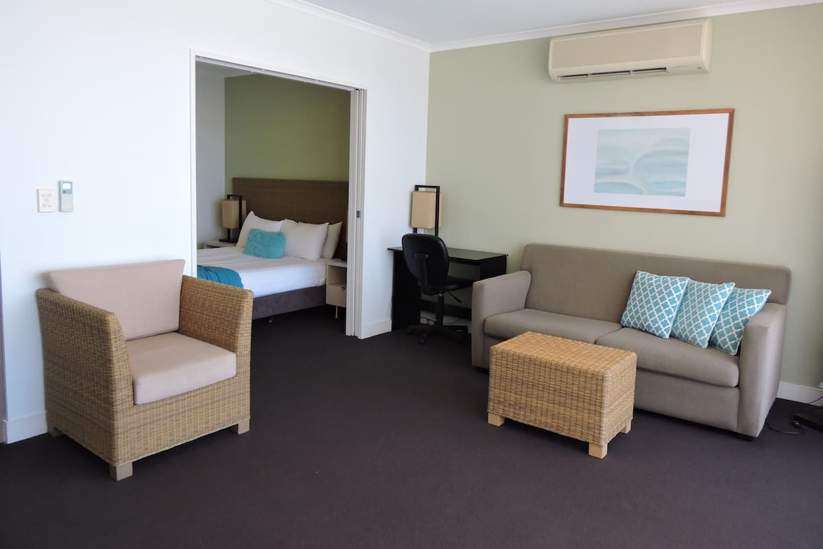 One Bedroom Suite with Town or Hinterland View | Living area | Flat-screen TV