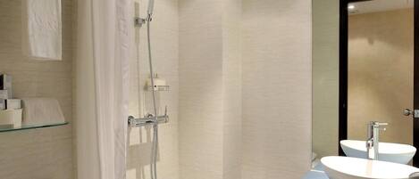 A modern bathroom with a shower, toilet, and sink.