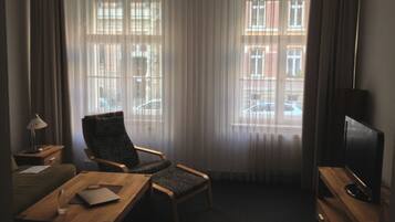 Apartment, 1 Bedroom | Living room | Flat-screen TV