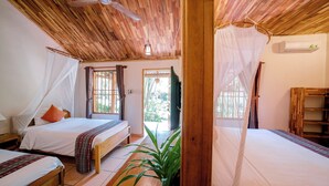 A room with two beds, wooden ceiling, ceiling fan, and a large window. - La Mer Resort (Phu Quoc)