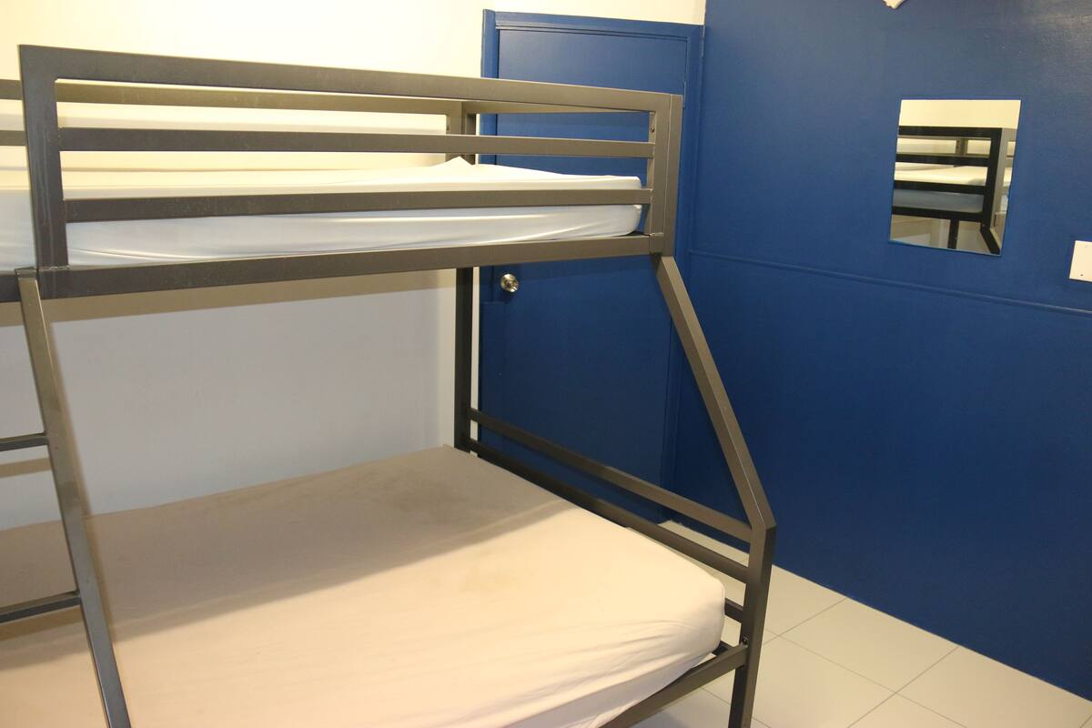 A bunk bed with a mattress and metal frame.